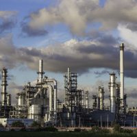 Oil​ refinery​ plant and tower column of Petrochemistry industry in tank oil​ and​ gas​ ​industrial with​ cloud​ blue​ ​sky the background​